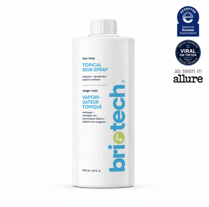 A white bottle of Topical Skin Spray features blue and yellow text, comes in a 950ml size, and is displayed with awards and media mentions on the right side of the image. This soothing spray helps calm irritation and reduces blemishes for healthier-looking skin.