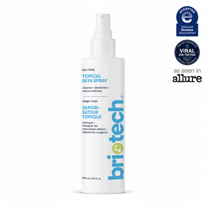 A white 250 mL (8.5 fl oz) bottle of Briotech Topical Skin Spray features blue text, a spray nozzle, and labels highlighting national recognition, TikTok popularity, and an “As Seen In Allure” mention. This soothing Topical Skin Spray helps calm irritation and reduce blemishes for a refreshed complexion.